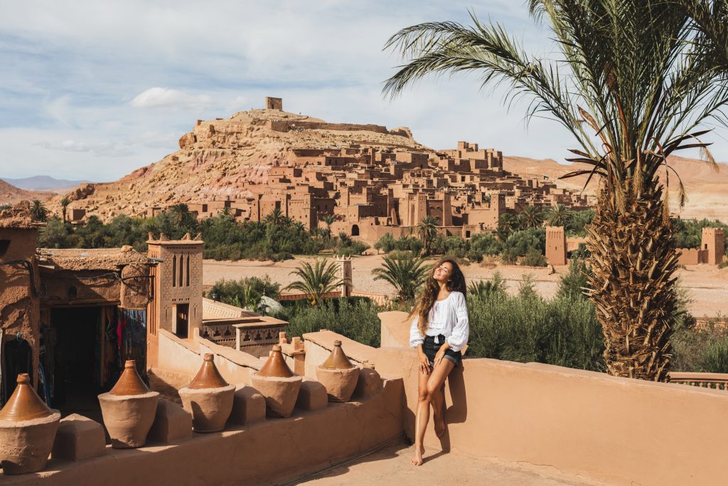 Young woman in Morocco with Ait-Ben-Haddou in the background.